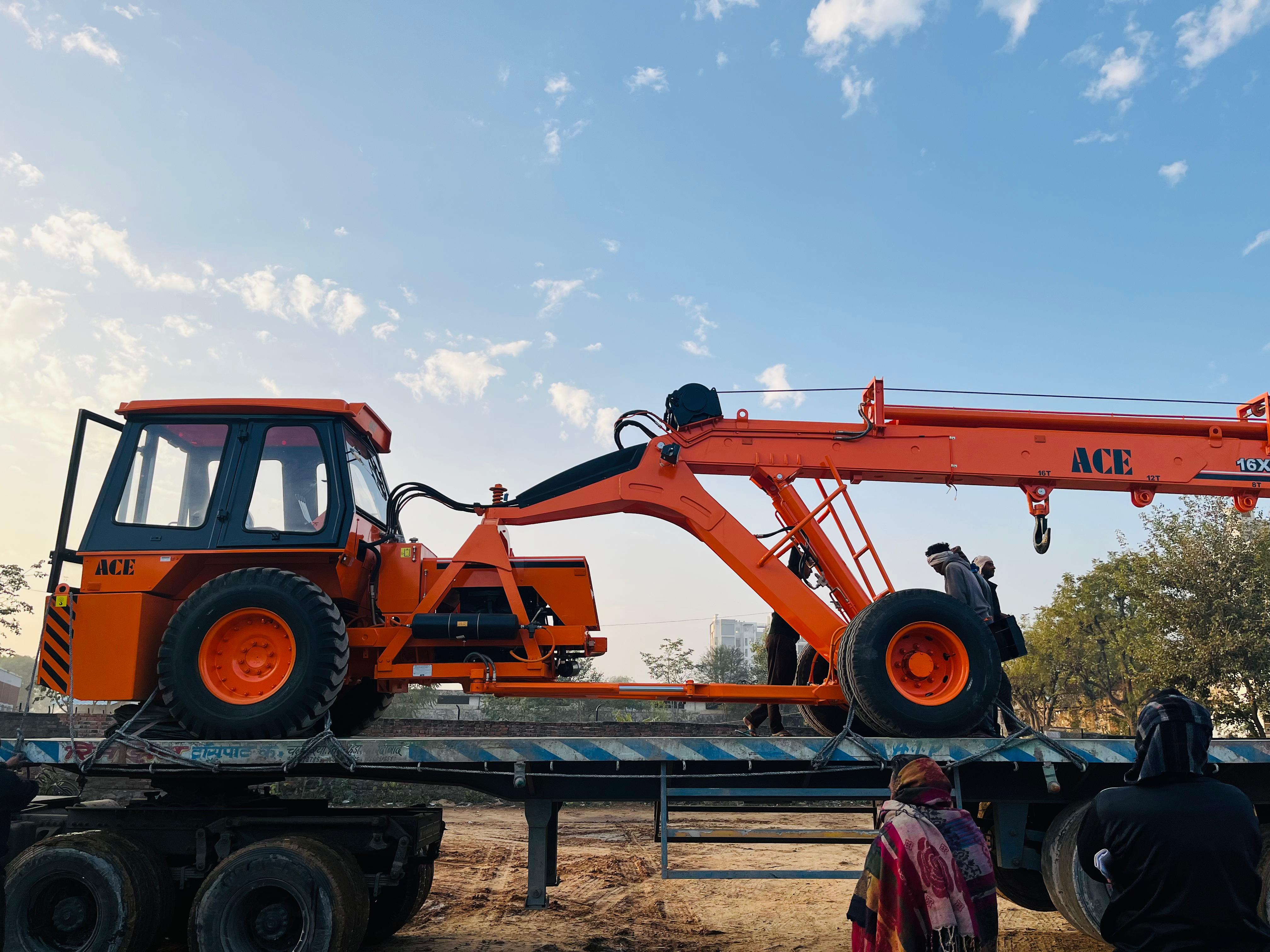 Hydra crane lifting heavy equipment on construction site in Jaipur